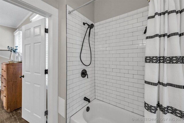 149 N Columbia Pl, Tulsa, OK 74110 - bathroom with shower / bath combo with shower curtain and wood finished floors