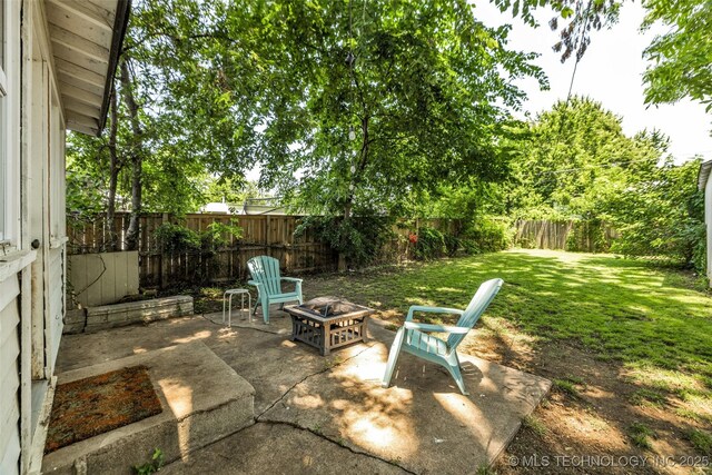 149 N Columbia Pl, Tulsa, OK 74110 - fenced backyard with a fire pit and a patio area