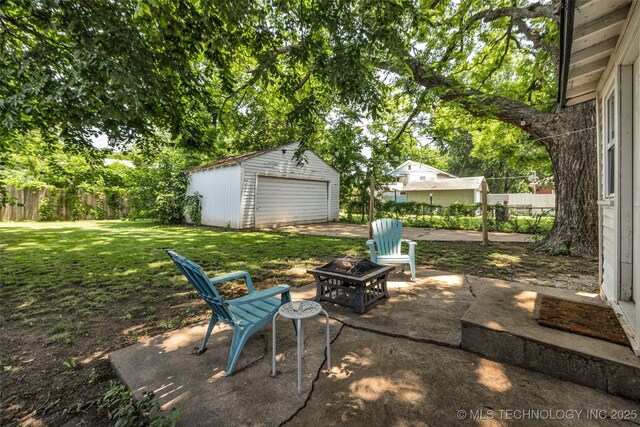 149 N Columbia Pl, Tulsa, OK 74110 - view of patio / terrace with an outdoor structure, a fire pit, and a garage