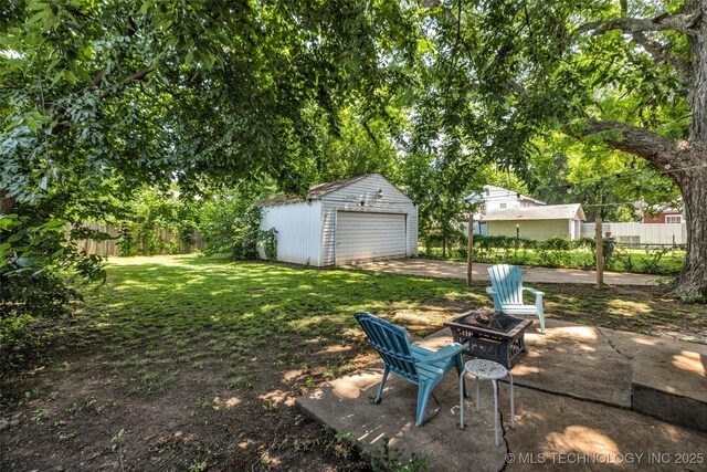 149 N Columbia Pl, Tulsa, OK 74110 - view of yard featuring an outbuilding, an outdoor fire pit, and a garage
