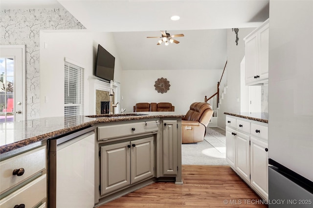 812 N Butternut Ave, Broken Arrow, OK 74012 - kitchen featuring dishwashing machine, ceiling fan, light wood-type flooring, dark stone countertops, and wallpapered walls