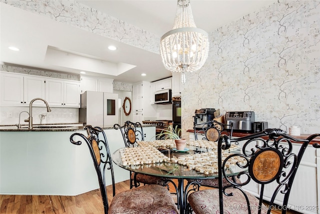 812 N Butternut Ave, Broken Arrow, OK 74012 - dining room featuring light wood-type flooring, recessed lighting, a chandelier, and a tray ceiling