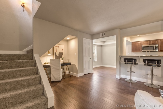 6376 S 80th E Ave Unit 41H, Tulsa, OK 74133 - unfurnished living room featuring dark wood finished floors and stairs