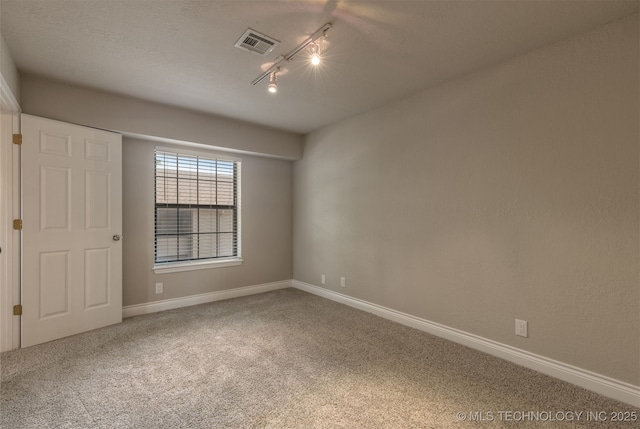 6376 S 80th E Ave Unit 41H, Tulsa, OK 74133 - empty room with carpet and track lighting