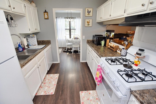 18185 Hilltop Cir, Tahlequah, OK 74464 - kitchen with white appliances, under cabinet range hood, white cabinetry, dark wood-style flooring, and dark countertops