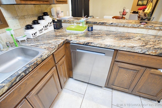21887 Coffee Hollow Rd, Tahlequah, OK 74464 - kitchen with dishwasher, backsplash, light tile patterned floors, and brown cabinets