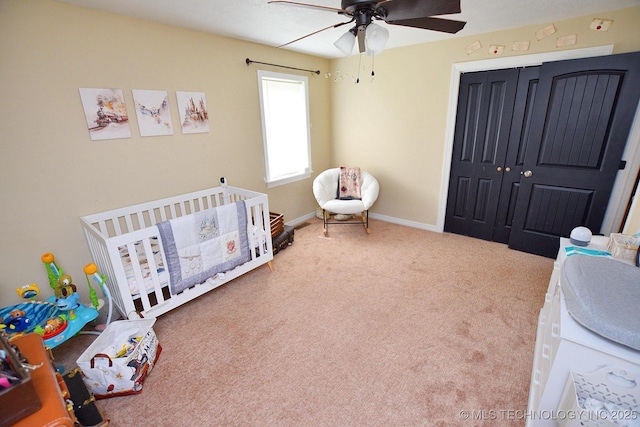 21887 Coffee Hollow Rd, Tahlequah, OK 74464 - bedroom featuring a crib, a closet, carpet flooring, and ceiling fan
