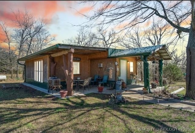 8420 S 145th W Ave, Sapulpa, OK 74066 - back of property featuring a patio area, a yard, a metal roof, and a standing seam roof