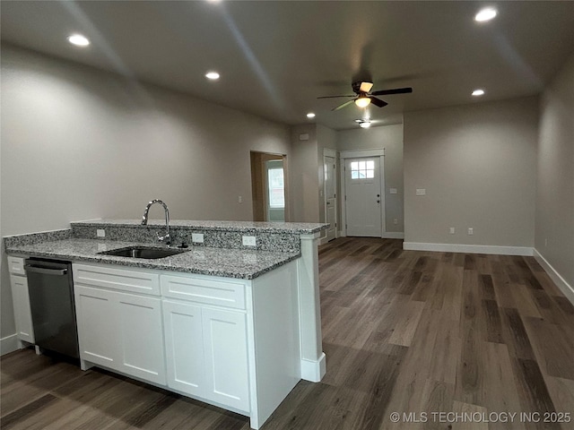 373 Worth Ave, Durant, OK 74701 - kitchen featuring dishwasher, ceiling fan, dark wood-style flooring, light stone countertops, and white cabinetry