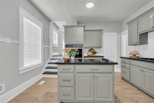 408 K SW, Ardmore, OK 73401 - kitchen with stainless steel oven, dark countertops, electric cooktop, and light wood-type flooring