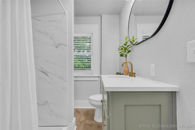 408 K SW, Ardmore, OK 73401 - bathroom featuring vanity, a marble finish shower, and wood finished floors
