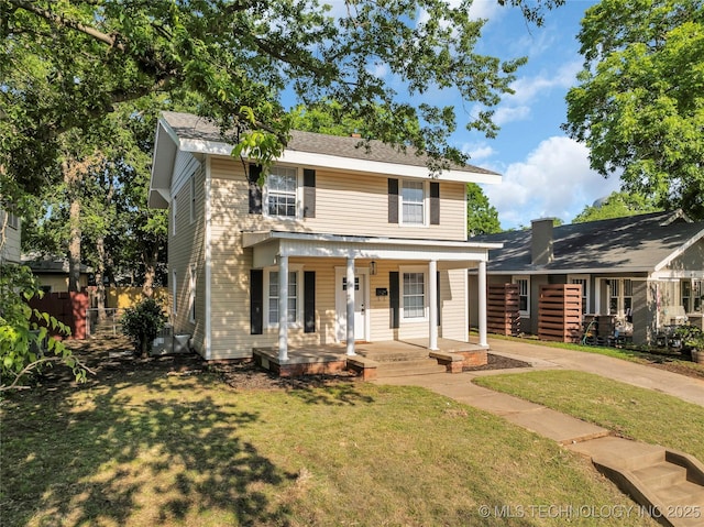 408 K SW, Ardmore, OK 73401 - view of front of home with covered porch, a front lawn, and concrete driveway
