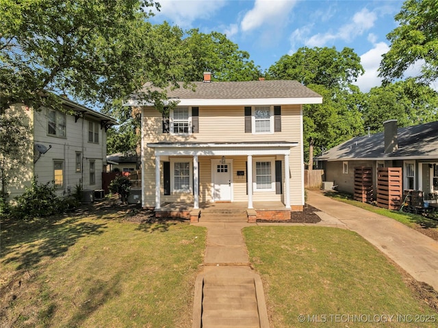408 K SW, Ardmore, OK 73401 - traditional-style home featuring covered porch, a front yard, and a chimney