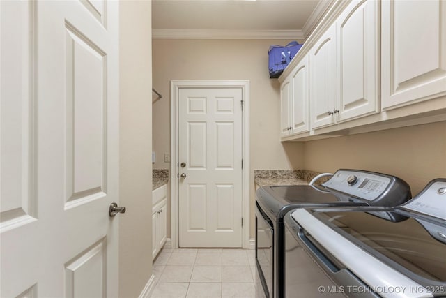 8811 E 110th St S, Bixby, OK 74133 - laundry room featuring washer and clothes dryer, crown molding, cabinet space, and light tile patterned flooring