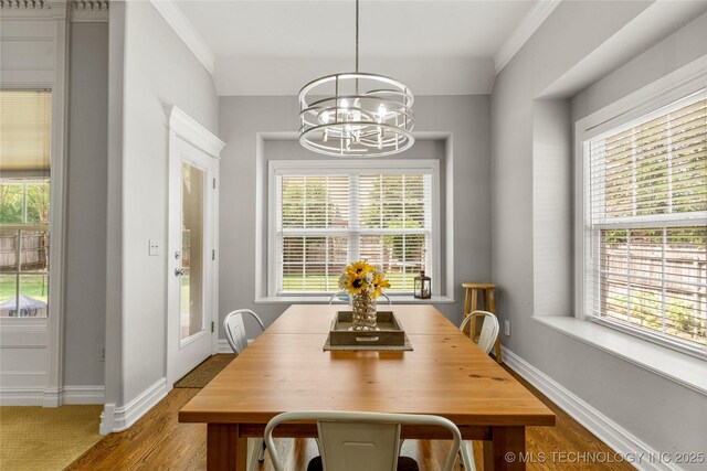 8811 E 110th St S, Bixby, OK 74133 - dining space featuring a chandelier, wood finished floors, and plenty of natural light