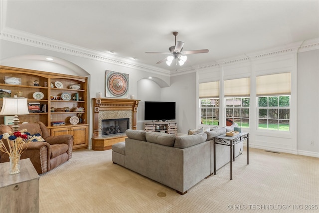 8811 E 110th St S, Bixby, OK 74133 - living area with light colored carpet, ceiling fan, crown molding, and a high end fireplace