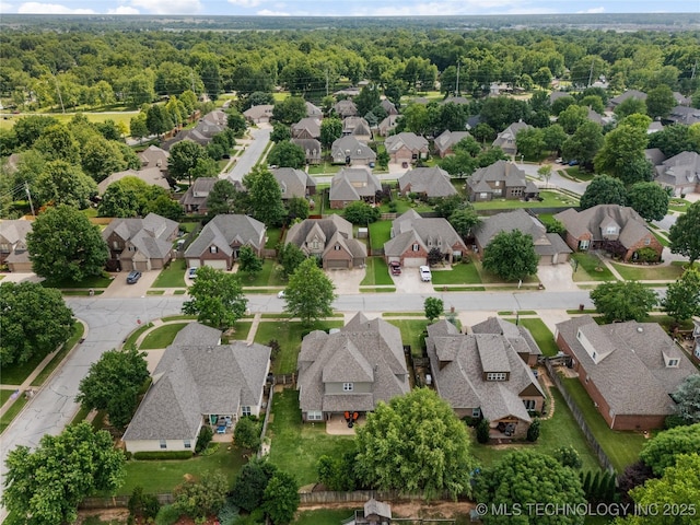 8811 E 110th St S, Bixby, OK 74133 - aerial perspective of suburban area featuring a heavily wooded area