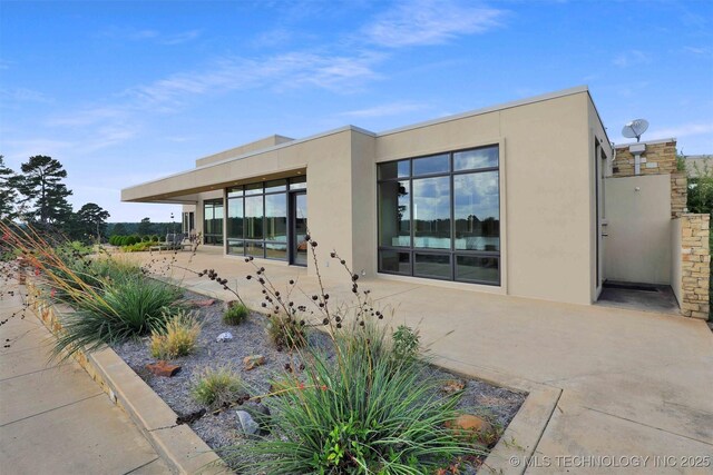 421403 E 1920th Rd, Antlers, OK 74523 - view of front of house with stucco siding and a patio area