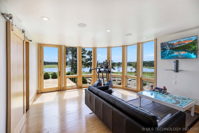 421403 E 1920th Rd, Antlers, OK 74523 - living area featuring expansive windows, light wood-style flooring, a barn door, and recessed lighting