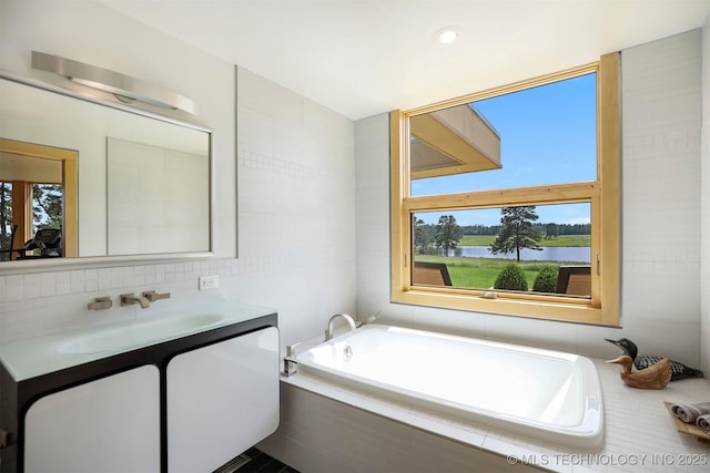 421403 E 1920th Rd, Antlers, OK 74523 - full bathroom with vanity, a garden tub, a water view, and tile walls
