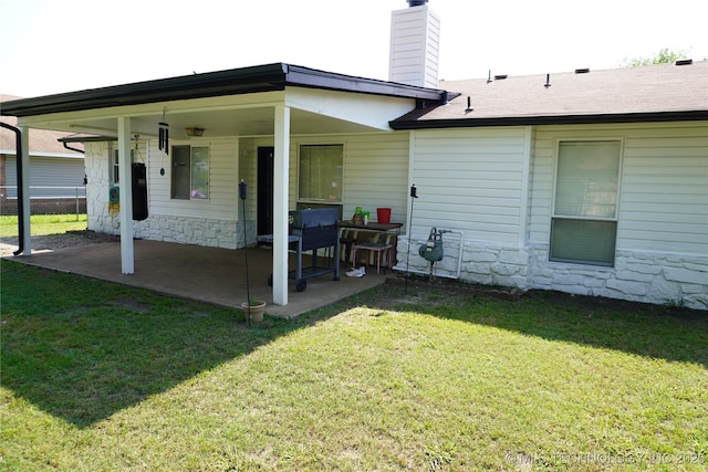 7817 N 122nd E Ave, Owasso, OK 74055 - rear view of property featuring stone siding, a chimney, a patio, and roof with shingles