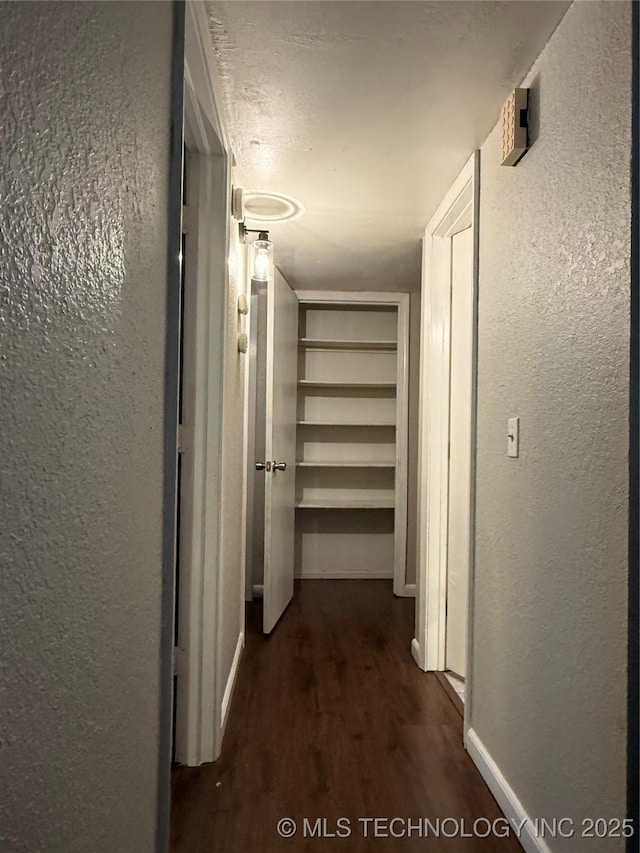 7817 N 122nd E Ave, Owasso, OK 74055 - hallway featuring a textured wall and dark wood-style floors
