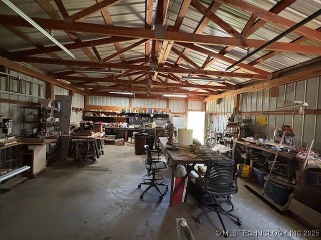902 NE Rushwood Dr, Stigler, OK 74462 - miscellaneous room with a workshop area, concrete floors, and lofted ceiling