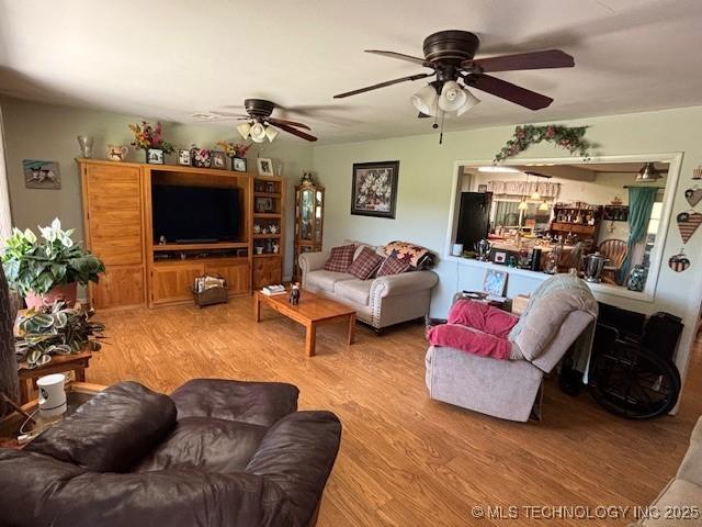902 NE Rushwood Dr, Stigler, OK 74462 - living area featuring ceiling fan and light wood finished floors