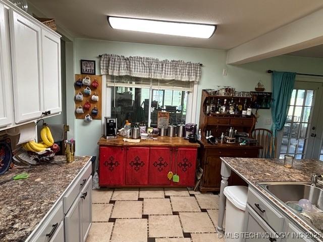 902 NE Rushwood Dr, Stigler, OK 74462 - bar area with plenty of natural light and light stone finish floors