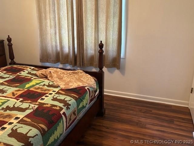 902 NE Rushwood Dr, Stigler, OK 74462 - bedroom with baseboards and wood finished floors