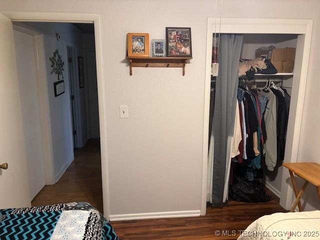 902 NE Rushwood Dr, Stigler, OK 74462 - bedroom with a closet, wood finished floors, and a spacious closet