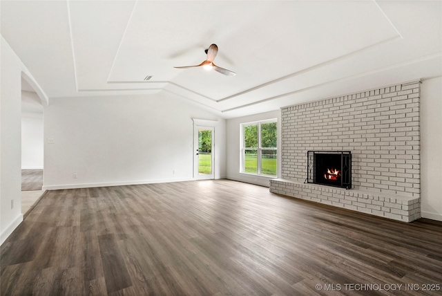 10062 E Northshire St, Claremore, OK 74017 - unfurnished living room with a ceiling fan, a fireplace, wood finished floors, lofted ceiling, and arched walkways