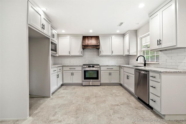 10062 E Northshire St, Claremore, OK 74017 - kitchen with stainless steel appliances, premium range hood, backsplash, light stone countertops, and recessed lighting