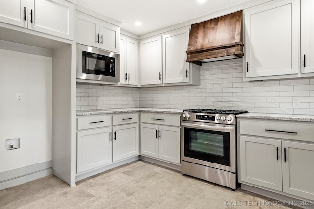 10062 E Northshire St, Claremore, OK 74017 - kitchen featuring stainless steel gas range, built in microwave, premium range hood, backsplash, and light stone counters