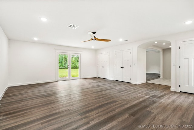 10062 E Northshire St, Claremore, OK 74017 - unfurnished living room with ceiling fan, recessed lighting, dark wood-style floors, and arched walkways