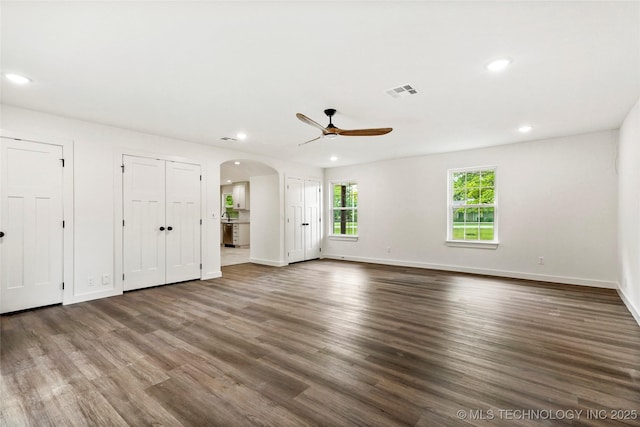 10062 E Northshire St, Claremore, OK 74017 - unfurnished bedroom with two closets, recessed lighting, wood finished floors, arched walkways, and a ceiling fan