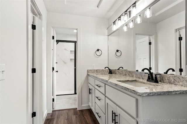 10062 E Northshire St, Claremore, OK 74017 - full bath featuring double vanity, a stall shower, and wood finished floors