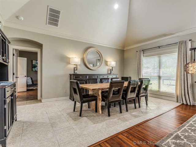 9025 N 100th E Ave, Owasso, OK 74055 - dining area with high vaulted ceiling, arched walkways, and ornamental molding