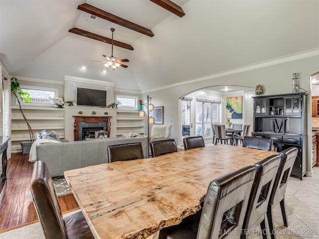 9025 N 100th E Ave, Owasso, OK 74055 - dining space featuring arched walkways, ceiling fan, a fireplace, and crown molding
