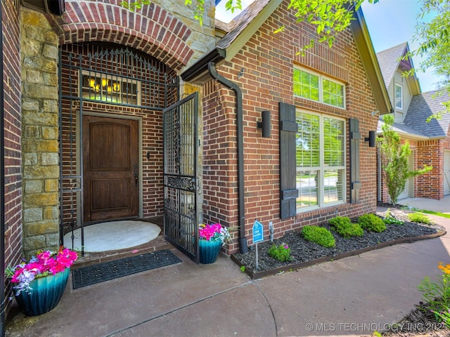 9025 N 100th E Ave, Owasso, OK 74055 - doorway to property with brick siding