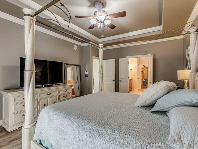 9025 N 100th E Ave, Owasso, OK 74055 - bedroom featuring a raised ceiling, crown molding, light wood finished floors, ensuite bathroom, and a ceiling fan
