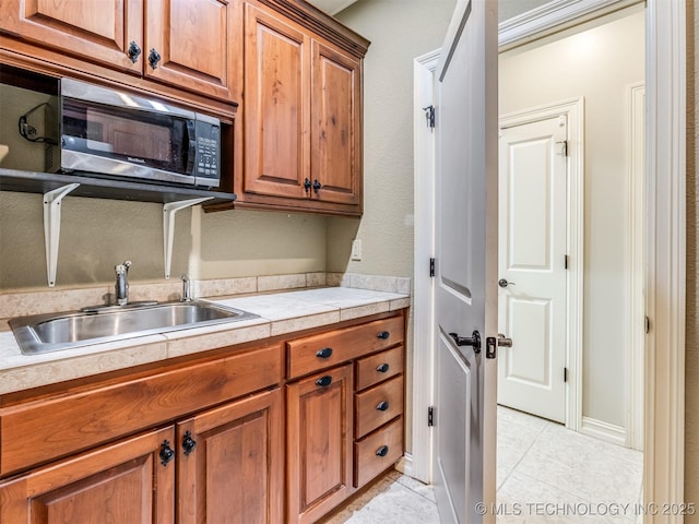 9025 N 100th E Ave, Owasso, OK 74055 - washroom featuring a sink and light tile patterned flooring