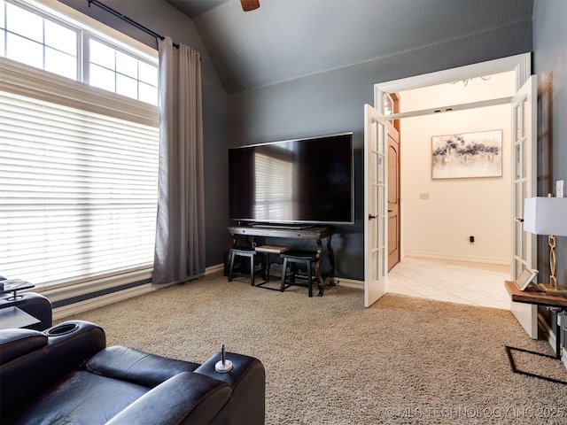 9025 N 100th E Ave, Owasso, OK 74055 - tiled living area featuring carpet flooring, vaulted ceiling, healthy amount of natural light, and ceiling fan