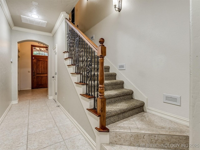 9025 N 100th E Ave, Owasso, OK 74055 - stairway with arched walkways, ornamental molding, and tile patterned floors
