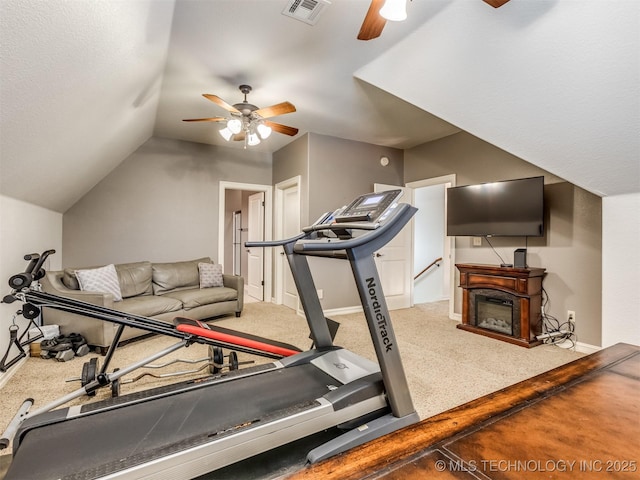 9025 N 100th E Ave, Owasso, OK 74055 - workout area featuring ceiling fan, carpet flooring, lofted ceiling, and a glass covered fireplace
