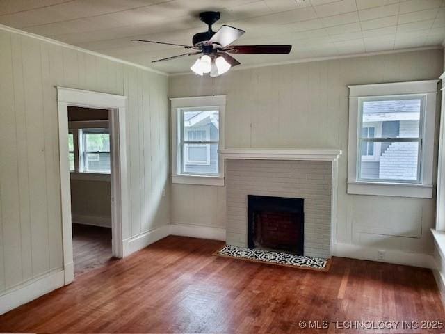 1319 Bixby St, Ardmore, OK 73401 - unfurnished living room with crown molding, wood finished floors, a ceiling fan, and a fireplace