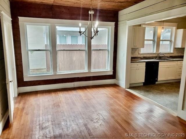 1319 Bixby St, Ardmore, OK 73401 - unfurnished dining area with a chandelier, light wood-style floors, and wood ceiling