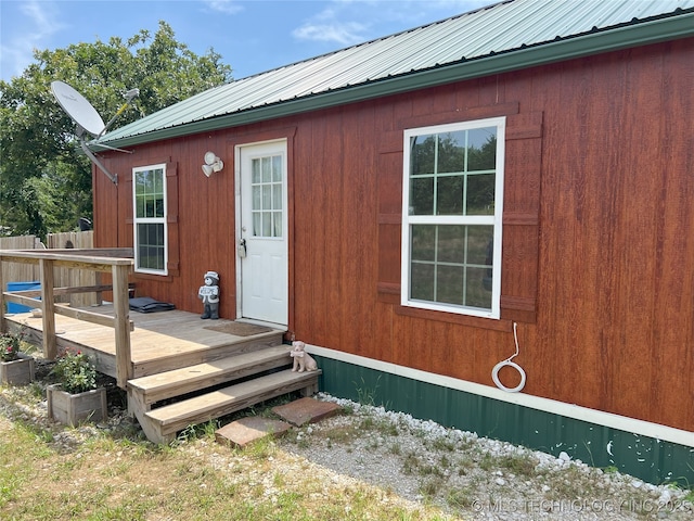 183006 N 4170th Rd, Moyers, OK 74557 - view of exterior entry with a wooden deck and a metal roof