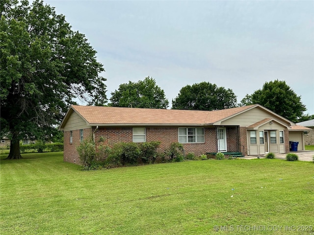 705 W 3rd St, Skiatook, OK 74070 - ranch-style house with brick siding, a front yard, and a garage