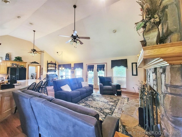 17978 W Stone Chapel Rd, Tahlequah, OK 74464 - living area featuring ceiling fan, wood finished floors, a stone fireplace, french doors, and high vaulted ceiling